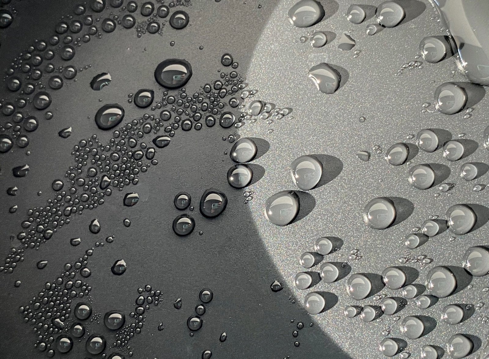 Water droplets glistening on a metal surface