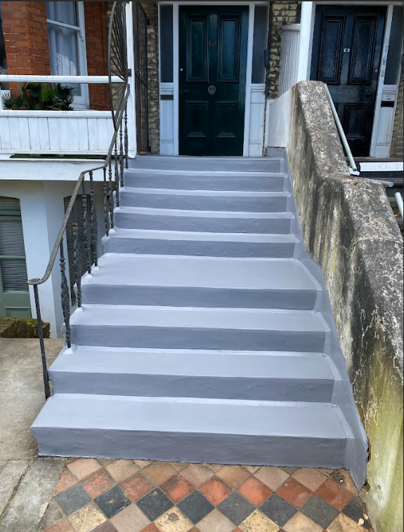 Grey stairs with black steps, showcasing a durable finish for asphalt step repair.